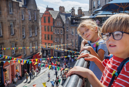 Children explore a scenic Victoria street with colorful bannersの写真素材
