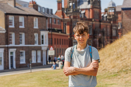 Teenage boy on school trip with backpack visit York, England