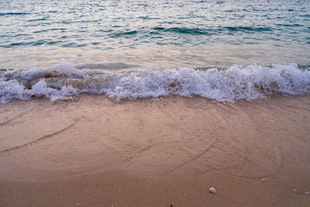 A caption of the shore of a beach of Dubai during the sunset lightsの写真素材