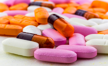 Medicine pills, tablets and capsules. Close up colorful pills background. Medical and health...