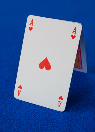 Poker playing cards isolated on a blue background.