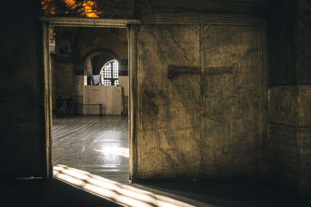 Istanbul, Turkey / September 03 2019: Interior view of the Hagia Sophia (Church of the Holy Wisdom). Door and cross detail with sunset lights.のeditorial素材