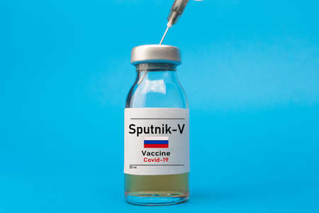 Coronavirus vaccine concept and background. New vaccine sputnik-v isolated on blue background. Covid-19, 2019-nCov pandemic.のeditorial素材
