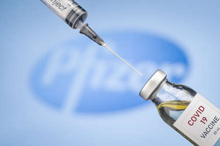 Izmir, Turkey - December 17 2020: Coronavirus vaccine concept and background. New vaccine pfizer and biontech isolated on blue background. Covid-19, 2019-nCov pandemic.のeditorial素材