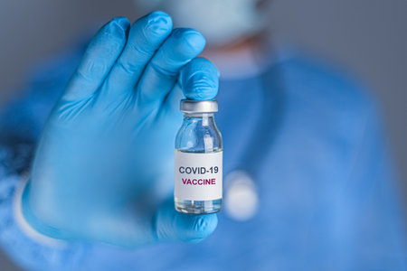 Coronavirus vaccine concept and background. The doctor is holding the Covid-19 vaccine.の写真素材