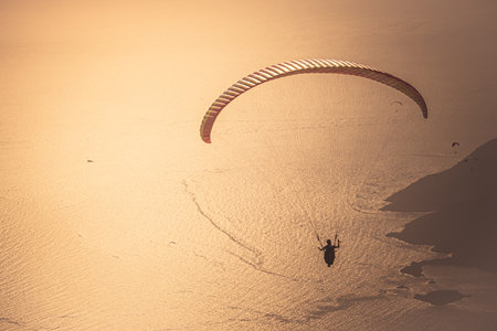 Paraglider flying over the Oludeniz at sunset. Fethiye, Mugla.