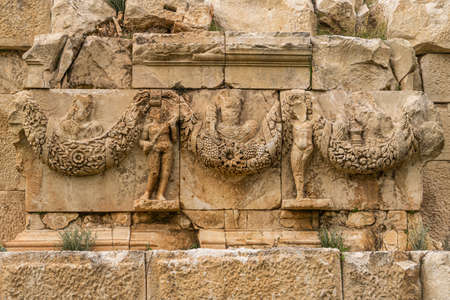Myra Ancient City. Preserved bas-reliefs with floral ornaments and faces. Demre, Antalya, Turkey