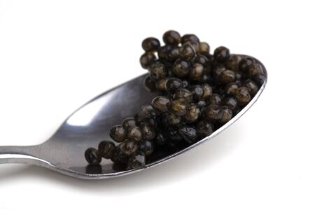 black caviar in spoon isolated on whiteの写真素材
