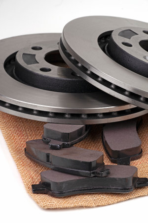 Brake discs and brake pads isolated on white. Auto partsの写真素材