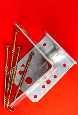 new nail dowel and profile on the red backgroundの写真素材