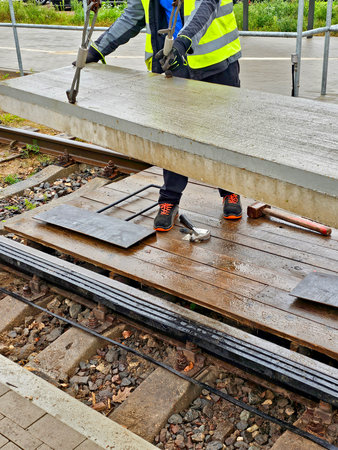 Worker on the platform of a railway station working on a construction siteの写真素材