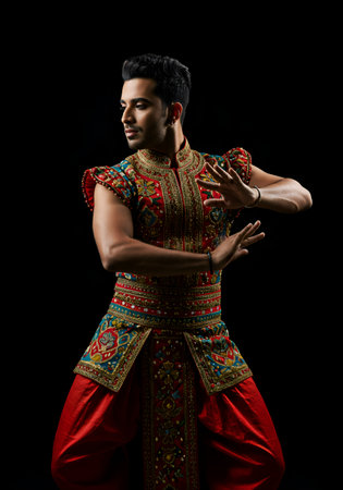 A captivating studio shot of a man in vibrant traditional Indian dance attire.の素材