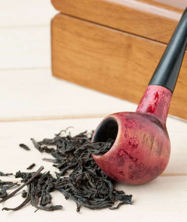 old pipe on the box of tobaccoの写真素材