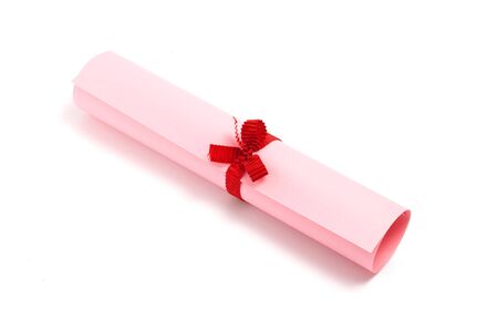 pink diploma scroll isolated on  white  backgroundの写真素材
