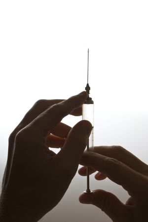 old glass syringe in handの写真素材