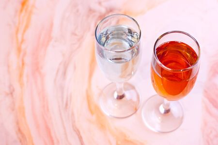 two glasses of wine on the marble tableの写真素材