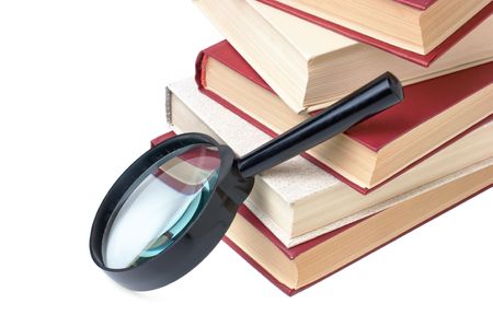 stack of books and magnifying glass isolatedの写真素材