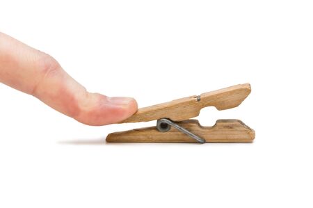 hand holds the clothespin isolated on a white backgroundの写真素材
