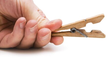 hand holds the clothespin isolated on a white backgroundの写真素材