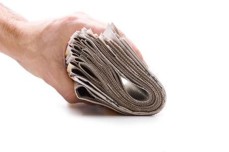 hand holds a bundle of newspapers isolated on a white backgroundの写真素材