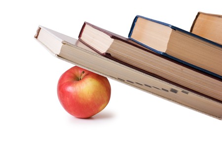 apple under a pile of books  isolated on whiteの写真素材
