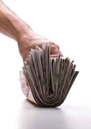 hand holds a bundle of newspapers isolated on a white backgroundの写真素材