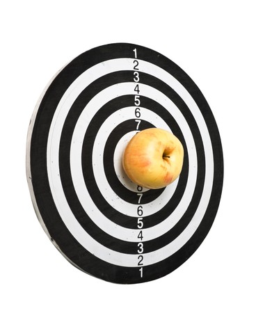 target and apple isolated on a white backgroundの写真素材