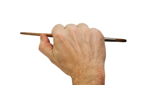 hand holds the brush to draw isolated  on white backgroundの写真素材