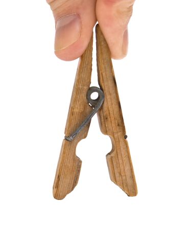 hand holds the clothespin isolated on a white backgroundの写真素材