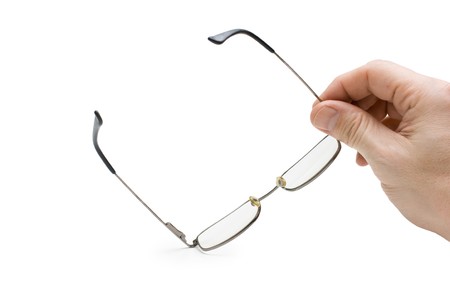 hand holds glasses isolated on whiteの写真素材