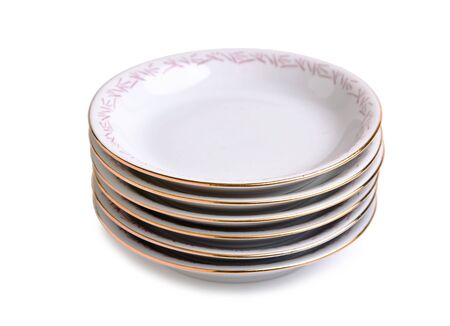 stack of porcelain plates isolated on a white backgroundの写真素材