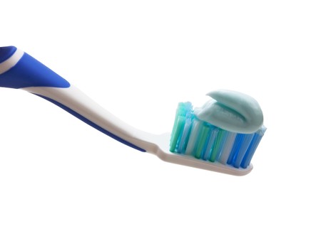 toothbrush with toothpaste squeezed out isolated