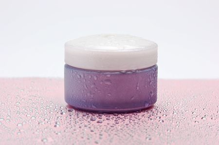 cosmetic cream jar wet isolated on a white backgroundの写真素材