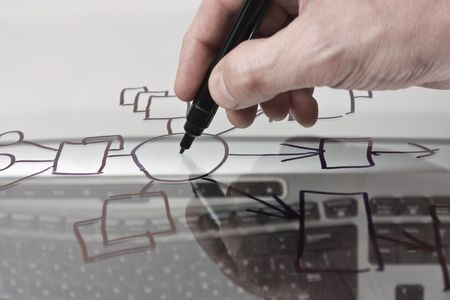 hand draws a block diagram on a transparent glassの写真素材