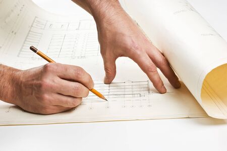 hand draws a pencil on the drawing