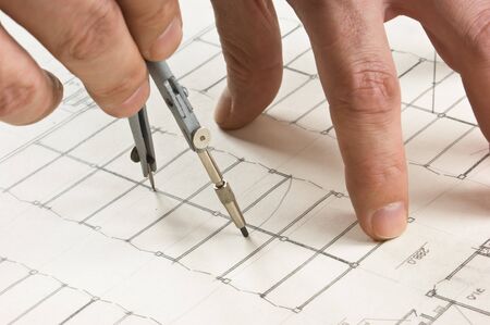 hand draws a pencil on the drawingの写真素材