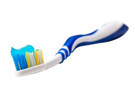 toothbrush and toothpaste isolated on a white background