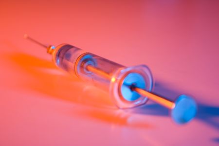 old glass syringe multicolored lightsの写真素材