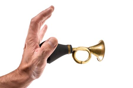 hand holds an old car horn  isolated on a white backgroundの写真素材