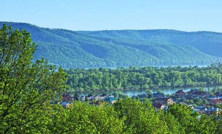Tranquil rural scenery with house and river in countryside. の写真素材