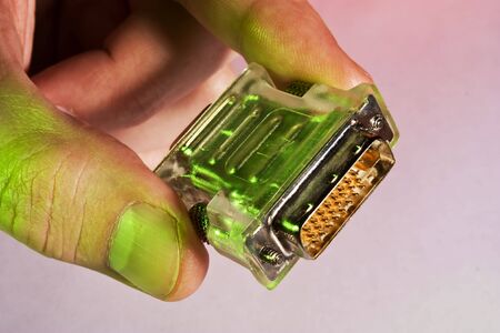 hand holds a computer plug in  multicolored lightsの写真素材