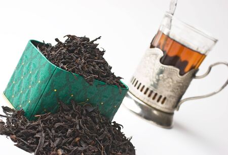 dry tea leaves in a box and glassの写真素材
