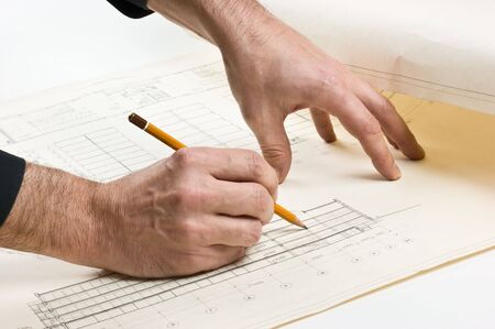 hand draws a pencil on the drawingの写真素材