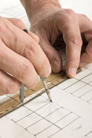hand draws a pencil on the drawingの写真素材