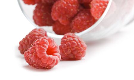 berries raspberries in a glass  isolated on white