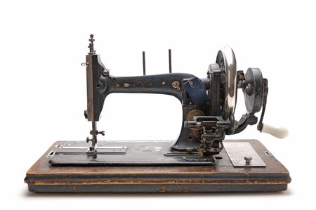 Old sewing machine isolated on a white background Old sewing machine isolated on a white background
