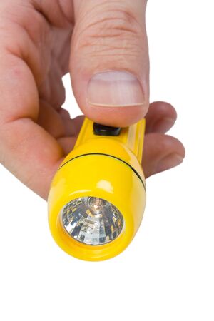 yellow plastic flashlight in hand isolated on white backgroundの写真素材