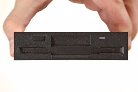 floppy disk drive in hand  isolated on white backgroundの写真素材