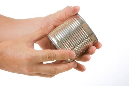 Food can in hand isolated on white backgroundの写真素材