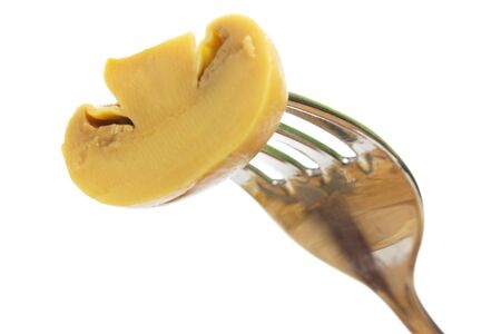 mushroom on a fork isolated on white backgroundの写真素材